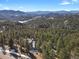 Aerial view of home showcasing mountain views and wooded landscape at 25220 Montane Dr, Golden, CO 80401