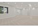 Spacious finished basement with large windows and neutral carpeting at 25220 Montane Dr, Golden, CO 80401