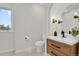 Bathroom with single vanity and toilet, view to backyard at 25220 Montane Dr, Golden, CO 80401