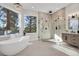 Spa-like bathroom with soaking tub, walk-in shower, and modern vanity at 25220 Montane Dr, Golden, CO 80401