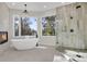 Bathroom with soaking tub, walk-in shower and fireplace at 25220 Montane Dr, Golden, CO 80401