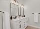Modern bathroom with double vanity, black accents, and large mirrors at 25220 Montane Dr, Golden, CO 80401