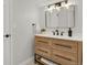 Contemporary bathroom with wood vanity, modern fixtures, and large mirror at 25220 Montane Dr, Golden, CO 80401