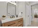 Clean bathroom with wood vanity, modern fixtures, and large mirror at 25220 Montane Dr, Golden, CO 80401
