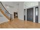 Grand entryway with hardwood floors and curved staircase at 25220 Montane Dr, Golden, CO 80401