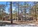 Home exterior showcasing stonework and tree-lined setting at 25220 Montane Dr, Golden, CO 80401