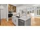 Bright kitchen featuring a spacious island and hardwood floors at 25220 Montane Dr, Golden, CO 80401