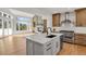 Open concept kitchen with high-end appliances and a stone fireplace at 25220 Montane Dr, Golden, CO 80401