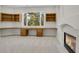 Basement office with built-in wood desk and a fireplace at 25220 Montane Dr, Golden, CO 80401