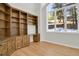 Home office with built-in shelving and hardwood floors at 25220 Montane Dr, Golden, CO 80401