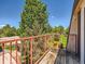 Balcony with a red railing overlooking lush greenery and a blue sky at 7755 E Quincy Ave # 301A7, Denver, CO 80237