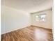 Bright bedroom featuring hardwood floors and a window with natural light at 7755 E Quincy Ave # 301A7, Denver, CO 80237