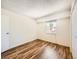 Bedroom with hardwood floors, a window, and closet at 7755 E Quincy Ave # 301A7, Denver, CO 80237