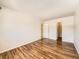 Bedroom showcasing hardwood floors, closet, and entry to attached bathroom at 7755 E Quincy Ave # 301A7, Denver, CO 80237