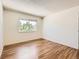 Bedroom with hardwood floors, natural light from a window, and closet at 7755 E Quincy Ave # 301A7, Denver, CO 80237