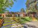 Exterior view of a building with red door, stairs, and wooden railings at 7755 E Quincy Ave # 301A7, Denver, CO 80237