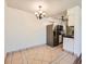 Dining area featuring tile flooring, a modern chandelier, and stainless steel refrigerator at 7755 E Quincy Ave # 301A7, Denver, CO 80237