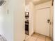 Apartment entrance featuring white walls and tile flooring, leading into the kitchen at 7755 E Quincy Ave # 301A7, Denver, CO 80237