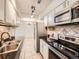 Updated kitchen featuring modern appliances, including stainless steel refrigerator and black cooktop at 7755 E Quincy Ave # 301A7, Denver, CO 80237