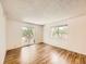 Bright living room featuring hardwood floors and a sliding glass door to a balcony at 7755 E Quincy Ave # 301A7, Denver, CO 80237