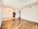 Open living room with hardwood floors, stainless steel refrigerator, and view to dining area at 7755 E Quincy Ave # 301A7, Denver, CO 80237
