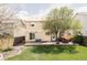 Rear exterior view of home highlighting the patio area, landscaped yard, and tranquil outdoor living space at 9469 W Ute Dr, Littleton, CO 80128