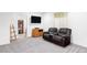 Cozy basement area with comfortable seating, perfect for relaxing and watching movies at 9469 W Ute Dr, Littleton, CO 80128