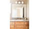 Bathroom vanity featuring granite counters, wood cabinetry, and modern faucet for a luxurious touch at 9469 W Ute Dr, Littleton, CO 80128