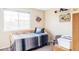Cozy bedroom with a daybed, soft natural light from the window, and decorative wall pieces at 9469 W Ute Dr, Littleton, CO 80128
