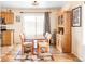 Bright dining area featuring hardwood floors, a modern light fixture, and a sliding door to backyard at 9469 W Ute Dr, Littleton, CO 80128