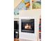 Close-up of a modern fireplace with white tile surround, perfect for creating a cozy ambiance at 9469 W Ute Dr, Littleton, CO 80128