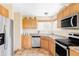 Well-equipped kitchen featuring stainless steel appliances, granite countertops, and ample cabinet space at 9469 W Ute Dr, Littleton, CO 80128