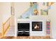 Cozy living room boasts a fireplace, staircase, and stylish decor, creating a welcoming atmosphere at 9469 W Ute Dr, Littleton, CO 80128