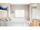 Spacious bedroom showcasing a bed with side tables, a large window with lots of natural light at 9469 W Ute Dr, Littleton, CO 80128