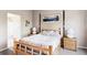 Comfortable primary bedroom featuring a rustic wooden bed frame, neutral tones, and decor at 9469 W Ute Dr, Littleton, CO 80128