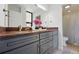 Bathroom with a red granite countertop, gray cabinets, and a shower with a curtain at 1111 Race St # 6B, Denver, CO 80206
