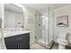 Modern bathroom featuring a glass shower with herringbone tile and a vanity with a marble countertop at 1111 Race St # 6B, Denver, CO 80206