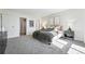 Bedroom with neutral walls, gray carpet, a big bed, and a doorway with a washer and dryer at 1111 Race St # 6B, Denver, CO 80206