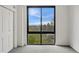 Bedroom with gray carpet, neutral walls, and a big window with a view of treetops and blue skies at 1111 Race St # 6B, Denver, CO 80206