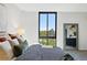 Bedroom with a big window looking out onto trees, a gray carpet, and a big mirror at 1111 Race St # 6B, Denver, CO 80206