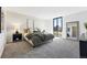 Bedroom with a big window, gray carpet, neutral walls, a big mirror, and modern decor at 1111 Race St # 6B, Denver, CO 80206