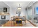 Elegant dining room with modern lighting, stylish furniture, and sliding glass doors to balcony at 1111 Race St # 6B, Denver, CO 80206