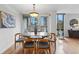 Dining room with a modern light fixture, stylish furniture, and access to an outdoor patio at 1111 Race St # 6B, Denver, CO 80206