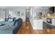 Hallway with hardwood floors connecting the living room and the modern kitchen with stainless steel appliances at 1111 Race St # 6B, Denver, CO 80206