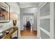 Hallway with beautiful hardwood floors, neutral walls, an art piece, and open doorways at 1111 Race St # 6B, Denver, CO 80206