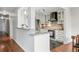 Bright kitchen features stainless steel appliances, white cabinetry, and granite countertops at 1111 Race St # 6B, Denver, CO 80206
