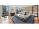 Bright living room features a stone fireplace, hardwood floors, and large windows with scenic outdoor views at 1111 Race St # 6B, Denver, CO 80206