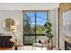 Cozy living room features hardwood floors, scenic outdoor views from large windows, and comfortable chair at 1111 Race St # 6B, Denver, CO 80206