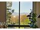 Breathtaking view from a window showcasing lush greenery and snow-capped mountains at 1111 Race St # 6B, Denver, CO 80206
