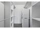 Walk-in closet with a stackable washer and dryer plus shelving for efficient storage at 1111 Race St # 6B, Denver, CO 80206